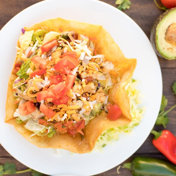 Serrano's Mexican Food taco salad in a crispy shell with chicken, tomatoes, cheese, and lettuce.