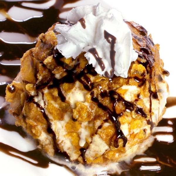 Serrano's fried ice cream with whipped cream and chocolate syrup drizzle.